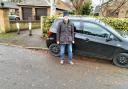 Malcolm Brown with one of the residents' cars on the pavement in The Beeches
