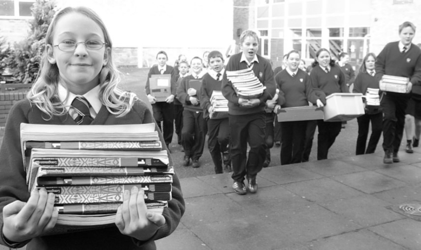 Molly Prior and classmates move text books into the new teaching block at Dyson Perrins High School in January 2003