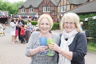 Clare Stowe and Mary Home enjoy a drink in their street
on Abercrombie Close Ledbury