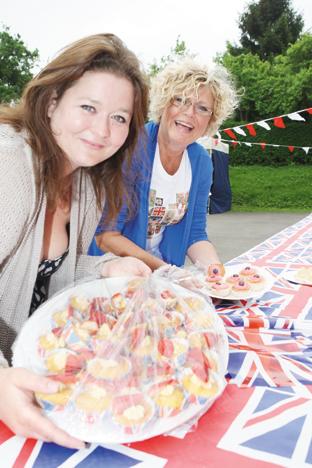 Mary Jenkins and Audra Allard put the food on the tabes in Callow End