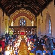 BEST BEHAVIOUR: Children celebrate Christingle at Crowle, near Worcester. Photograph by Bob Brierley