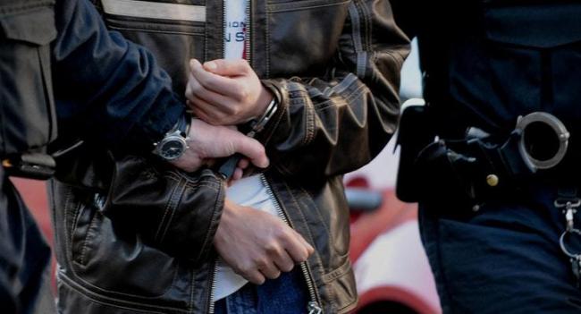 An arrestee in handcuffs