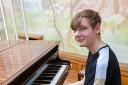 Alex playing piano for residents of Davenham