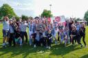 Malvern Town players, coaches and staff celebrate after securing their promotion