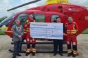 Mayor Nick Houghton hands over a cheque for £250 to the Midlands Air Ambulance
