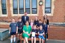 Headteacher Martyn Bream, teacher Becky Hughes and care home manager Sarah Cadwallader with members of the Malvern Parish Primary School Council