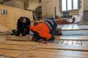 Workmen work on the Priory's new floor