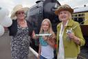 CELEBRATIONS: The centenary baton was handed over at the Sever Valley Railway station in Kidderminster to Gill Lowe (left) from Veronica Herridge (right) and her granddaughter Kate Gittins