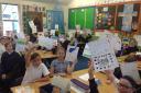 KIND: Pupils at Northleigh Church of England Primary School with their postcards