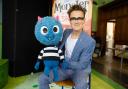 McFly guitarist and the production's author Tom Fletcher pictured with 'Little Monster'