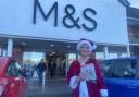 Jackie Collins giving out Christmas cards outside M&S in Malvern