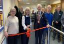 Pictured (l-r) Kate Walton, Harriett Baldwin MP, Malvern Town Mayor Clive Hooper and Community Action chair Mike Amery with volunteers and supporters at the new Malvern Link HQ.