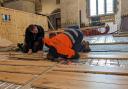 Workmen work on the Priory's new floor