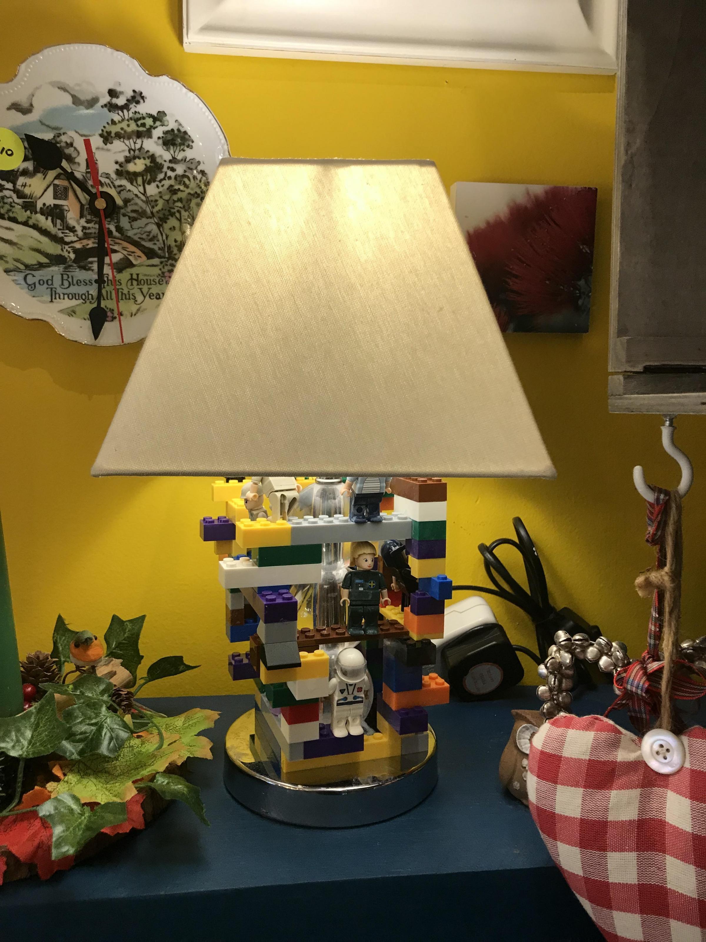A light made from donated Lego characters for sale in the shop