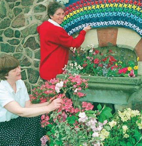 Margaret Baddeley (left) and Glenys Burrows decorate the fountain at Great Malvern railway station in the annual well dressing event in April 2002