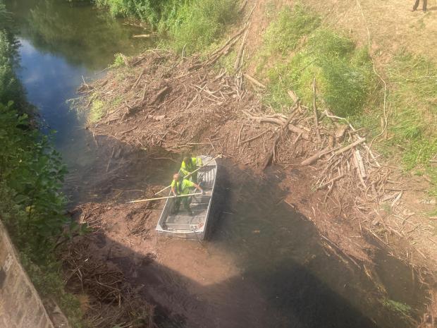 Malvern Gazette: DEDICATED: Environment Agency officials had their hands full clearing the blockage from the River Teme. They are pictured here from the top of the Powick Old Bridge. Photo: James Connell