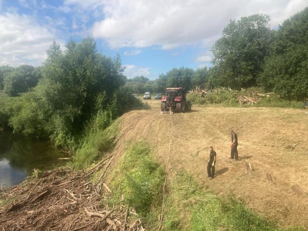 Malvern Gazette: HEAVY: This big tractor is the ideal piece of kit for dragging all the debris out of the River Teme. Photo: James Connell