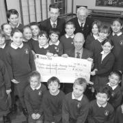 Rupert Chambers (back left), Bert Loynes (back right), Upton CofE headteacher Mark Mumby and pupils with a cheque for £15,000 from the friends group to pay for the refurbishment.