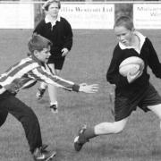 A player from St Joseph’s tries to grab the tag of an Upton player in Malvern Hills District Tag Rugby festival.