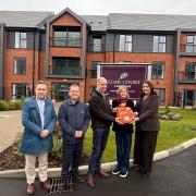From left: David Williams, site champion QinetiQ, Nick Houghton - head of site QinetiQ, Christopher  Walker - managing director QinetiQ, Lucy Chenevix-Trench patron Heartstart Malvern and Sarah Cadwallader, general manager at Elgar Court Care Home.