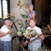 FLORAL: Sandra Starkey, Ann Oldfield and Christine Peer prepare for the event at Great Malvern Priory. 2813356301
