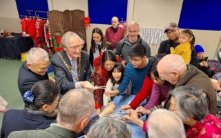 The Mayor of Malvern Coun Clive |Hooper joins others in the prosperity lift, lifting the ingredients high into the air with chopsticks. The higher the lift the greater the fortune believed to be bestowed.